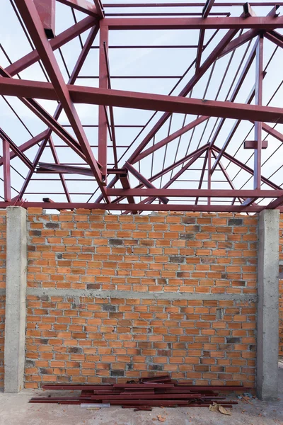 structural steel beam on roof and brick wall of building