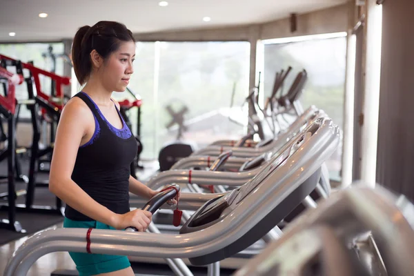 sport woman young person running on treadmill in fitness gym