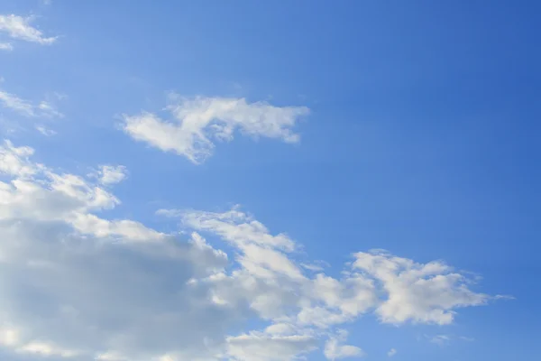 sunlight through cloud on clear blue sky background