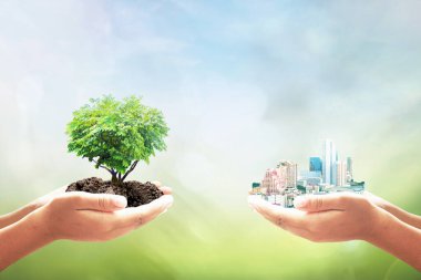 Sürdürülebilir kalkınma hedefleri (SDG 'ler) kavramı: Ağaç ve büyük şehrin kalp şeklindeki iki insanın el ele tutuşması