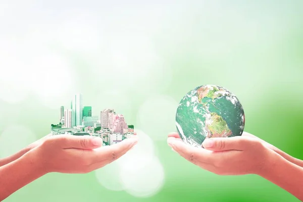 Corporate Social Responsibility (CSR) concept: Businessman and entrepreneurship hand holding big city and earth globe over blurred nature background. Elements of this image furnished by NASA