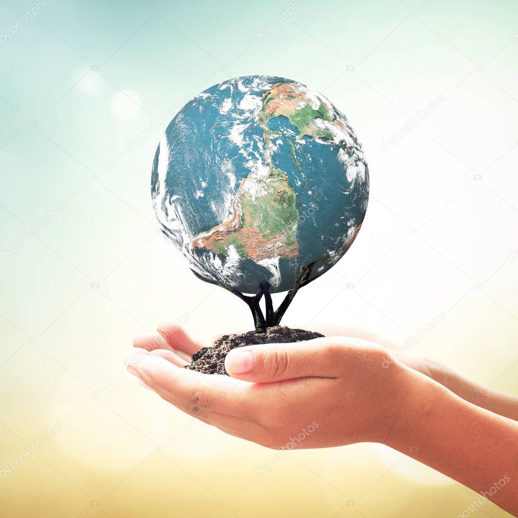 Corporate social responsibility (CSR) concept: Human hands holding tree of earth global over blurred nature background. Elements of this image furnished by NASA