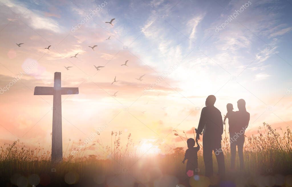 Easter Sunday concept: Silhouette family looking for the cross of Jesus Christ on autumn sunrise background