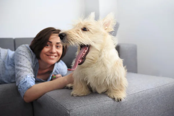 Genç kadın bir köpek vasıl ev ile. 