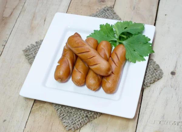 Sosis beyaz tabakta izole maydanoz ile