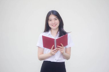 Taylandlı yetişkin üniversite üniforması güzel kız bir kitap okudu.