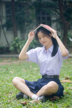 Taylandlı liseli üniformasının portresi. Genç güzel kız mutlu ve rahat.