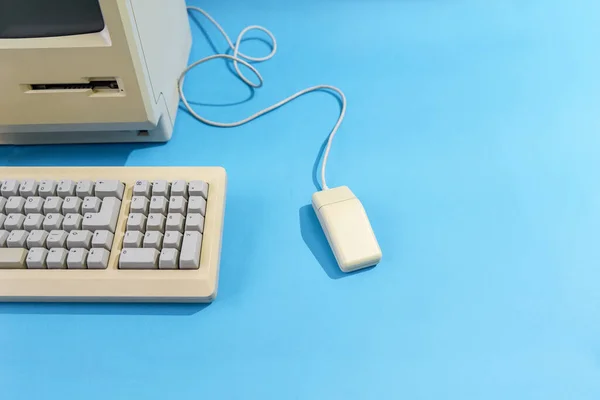 personal computer with keyboard and mouse. old desktop computer on a blue background