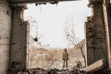 Gezgin çocuk. Silahlı bir çocuk. Çocuk terk edilmiş bir binaya gidiyor. Çocuk bir binanın önünde duruyor. Kıyametten sonra. Çocuk, kıyamet sonrası bir dünyada yiyecek aramak için yaya olarak seyahat ediyor..
