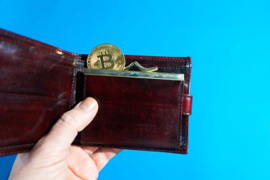 Deri cüzdanda Bitcoin altın para. Bitcoin bir adamın elinde.