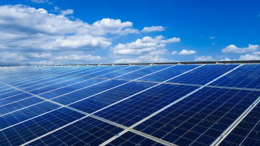 Bir evin çatısına kurulmuş güneş panelleri, beyaz bulutlar, mavi gökyüzü ve güneş ışığı ile kuş dışkıları yüzünden kirlenir. Eve güç sağlamak için, yeşil enerji kavramına ulaşmak için.