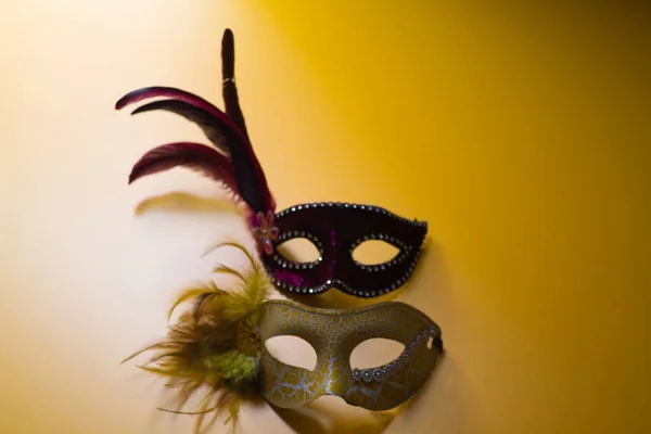 Two Carnival Masks One Yellow One Purple Feathers Yellow Background — Stock Photo, Image