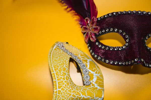 Two Carnival Masks One Yellow One Purple Feathers Yellow Background — Stock Photo, Image