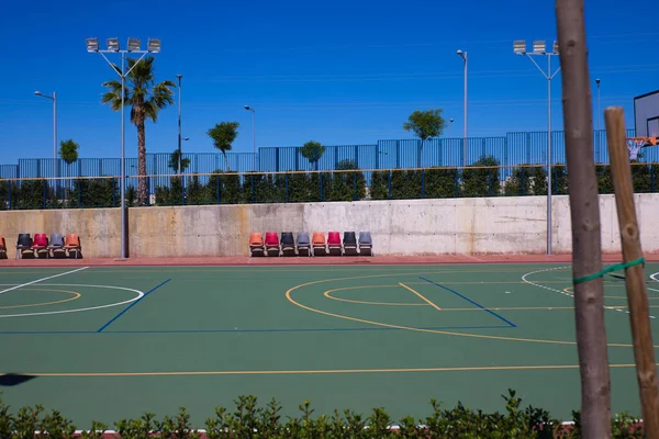Detail of the university sports courts after classes when they are completely empty. You can see the chairs for the reserves of each sports team.
