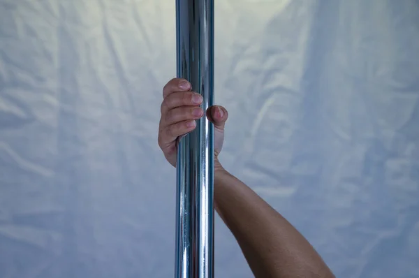 details of pole dancer's hands holding the pole. Concept sport, dance, health