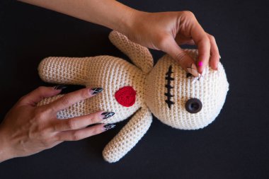 Bebek üzerinde vudu yapan cadı bir kadının detayları. Bebeğe nasıl iğne batırdığını görebilirsiniz. Büyücülük.