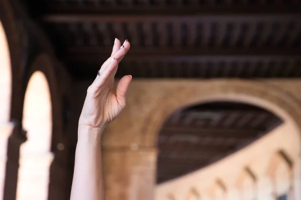 Classical ballet dancer\'s hand. The hand is raised above the head. Classical ballet concept