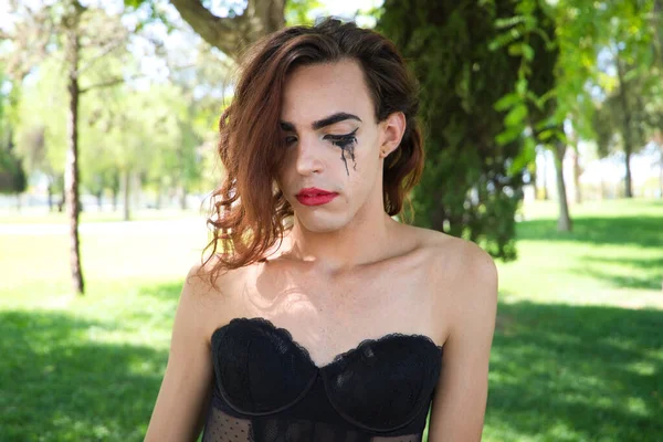 young latina and transsexual woman dressed in fine black lingerie. The woman is posing for the camera with her mascara smudged from crying because of discrimination. Concept diversity, transgender, homophobia
