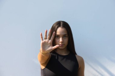 Kadın kamerayı durdurma hareketini gösteriyor. Kadın oy hakkı ve cinsiyet eşitliği için aile içi şiddet ve ırkçılığa karşı savaşıyor. Küresel kadın hakları hareketi kavramı. İzole edilmiş arkaplan