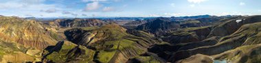 Aerial shot of multicolored mountains and valleys in Iceland, showcasing erosion and natural textures.