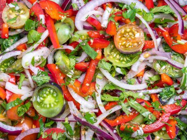 Fresh vegetable salad with cherry tomatoes, onions, peppers, and herbsvibrant and healthy.