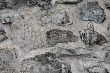 Taş bir duvarın dokusu. Eski kale taşından duvar dokusu. Arka plan ya da doku olarak taş duvar. Bir taş duvarın parçası, arkaplan veya doku için.