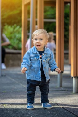 Parkta oynayan küçük sarı saçlı çocuk. Mutlu çocuk..