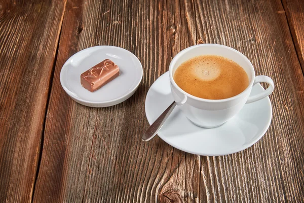 Chocolate bar on a brown wooden table — Stock Photo, Image