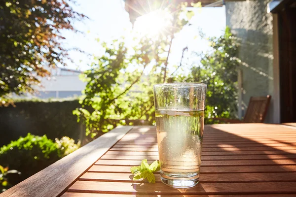 Cool drink with mint and ice on table