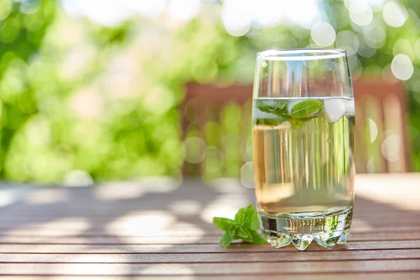 Fresh mint drink with ice in a glass on  a wooden table — Stock Photo, Image