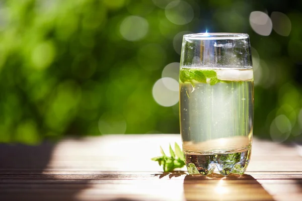 Fresh mint drink with ice in a glass on  a wooden table — Stock Photo, Image