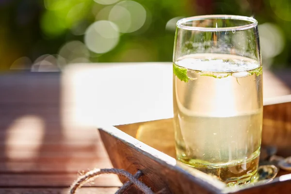 Fresh mint drink with ice in a glass on  a wooden table — Stock Photo, Image