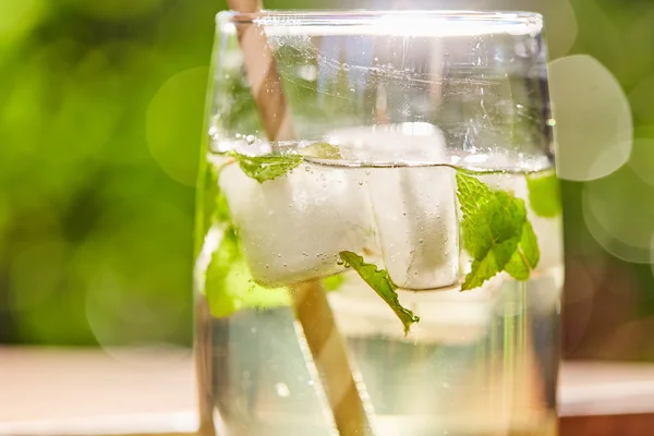 Fresh mint drink with ice in a glass on  a wooden table — Stock Photo, Image