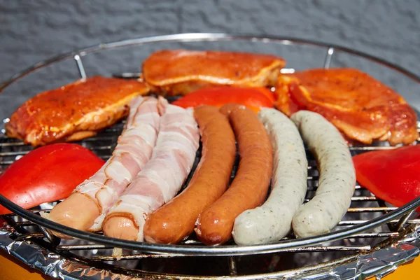 Barbecue grill with meat and sausages — Stock Photo, Image