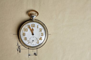 Old pocket watch on old paper