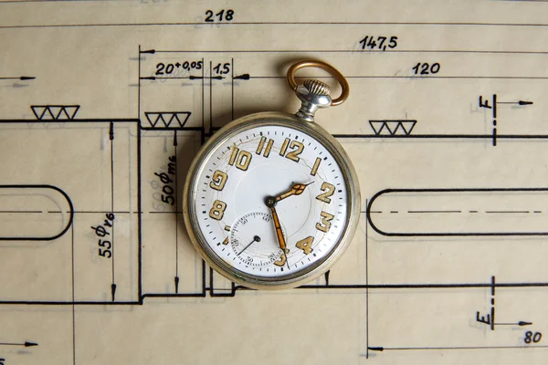 Old pocket watch on old paper — Stok fotoğraf