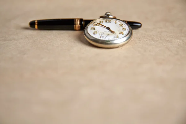 Old pocket watch on old paper — Φωτογραφία Αρχείου