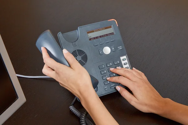 Mulher discando em um telefone — Fotografia de Stock