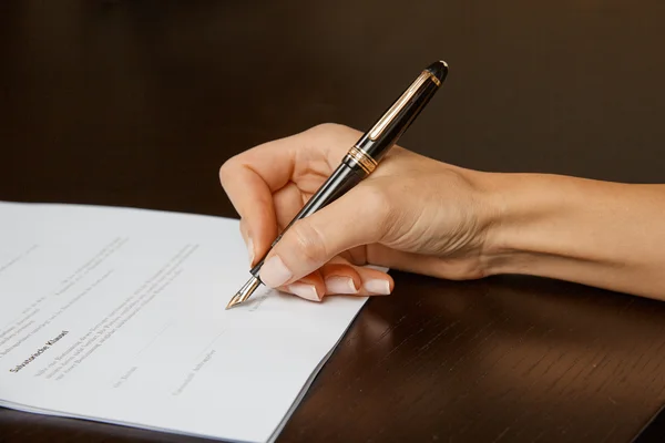 Woman writing on white paper — Stock Photo, Image