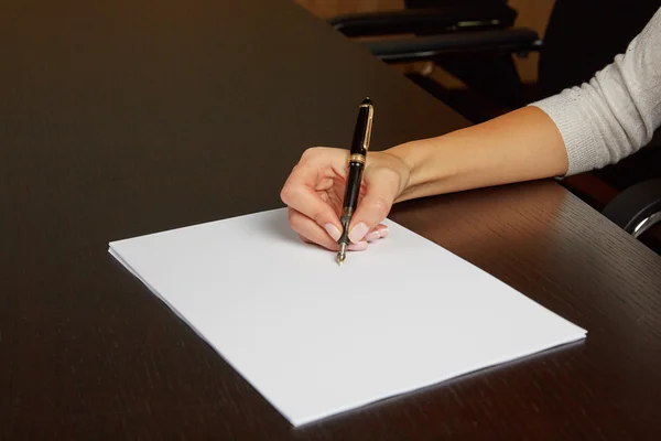 Woman writing on white paper — Stock Photo, Image