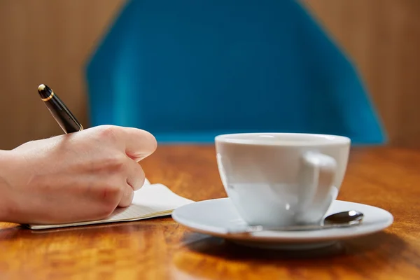 Woman writing in notebook — Stock Photo, Image