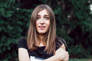 Yüzünde sürpriz ile duran güzel kız öğrenci .