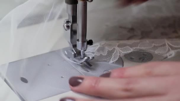 Seamstress , sewing lace wedding dress on the sewing machine . — Stock Video