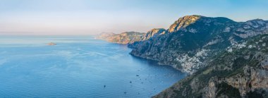 Amalfi Sahili 'nin panoramik manzarası, Positano sahil köyü ve plajı, dinlenme tekneleri bir körfeze demirlemiş ve İtalya' nın Kampüs kentindeki Tanrıların ünlü yürüyüş yolundan gelen manzaralı uçurumlar