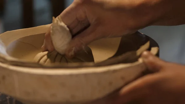 Raw Clay for Pottery Modeling with a Putty Knife and Molding Tools