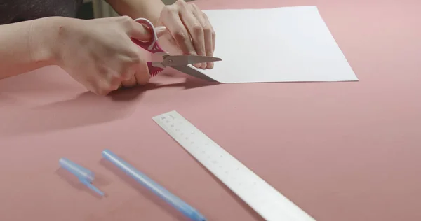girl cuts paper with scissors
