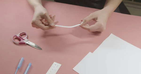 girl doing measurement for ring size