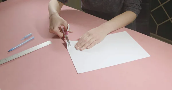 stock image girl cuts paper with scissors