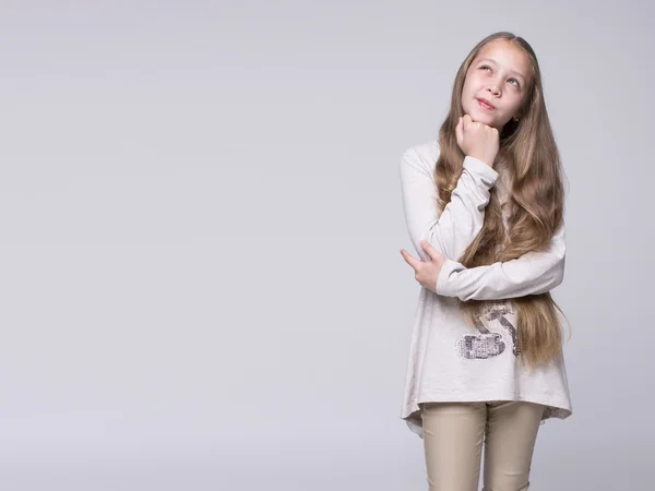 Porträt eines verwirrten Teenagers auf grauem Hintergrund — Stockfoto
