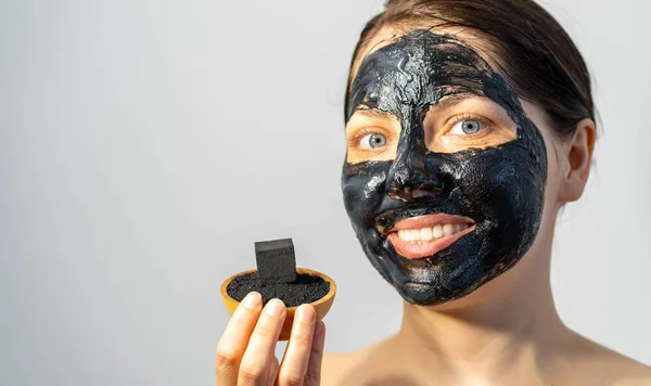 Emotional Woman Black Charcoal Face Mask Friable Coals Her Hands — Stock Photo, Image